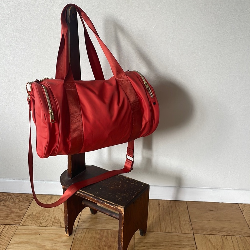 Adorable mini duffle in hot orange! Bag made by State.